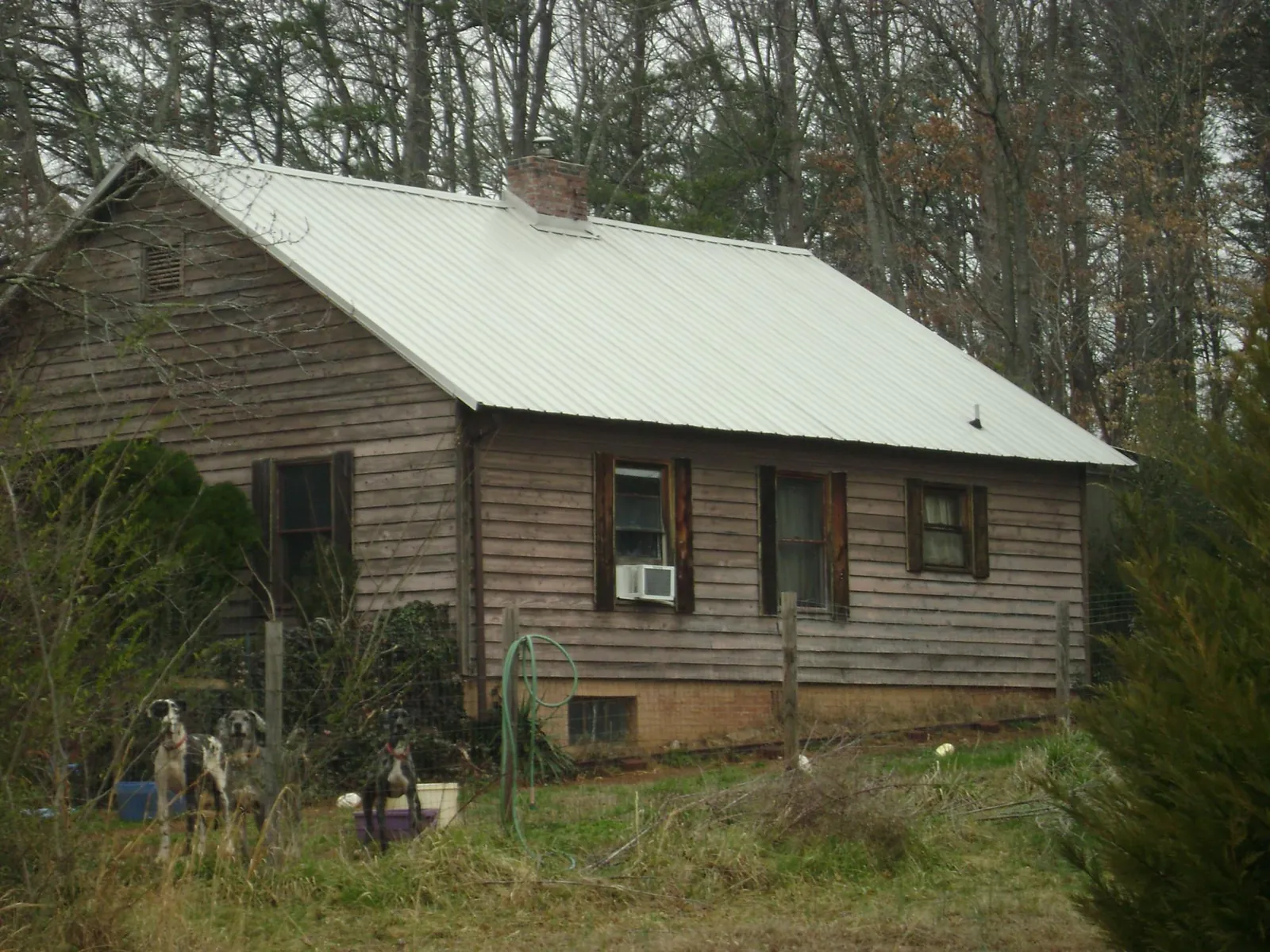 White metal roof on an old wood sided farmhouse, from a Asphalt Shingle Roof Repair job in Little Rock